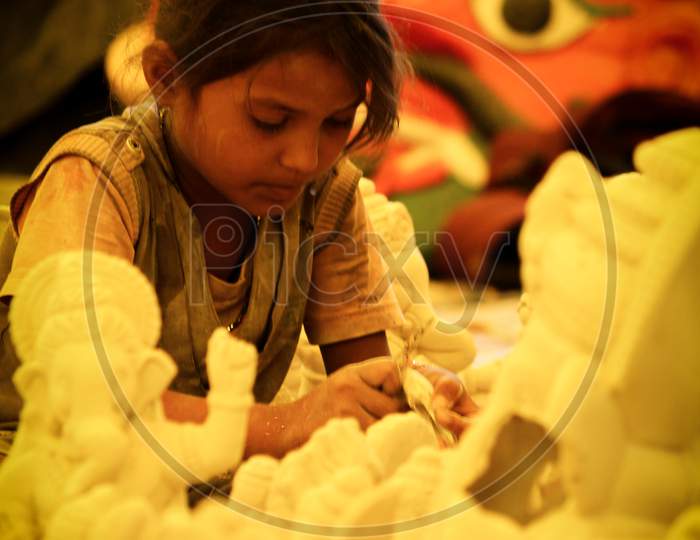 Kids crafting the Lord Ganesh idol