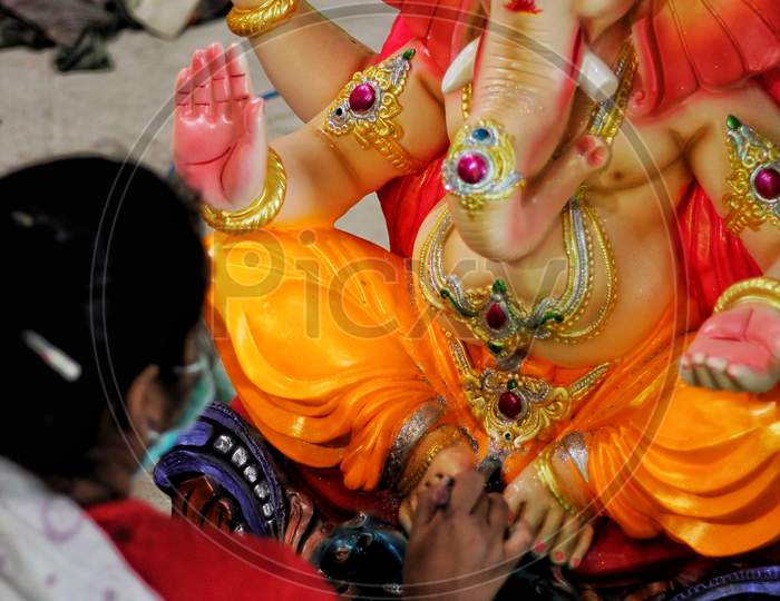 Women Coloring Idols Of Lord Ganesha