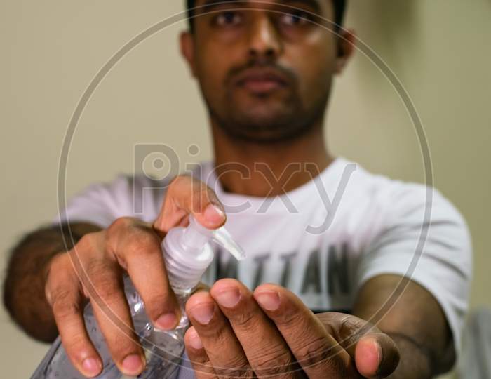 An Indian Man Taking Hand Sanitizer To His Hand To Disinfect From Corona Virus