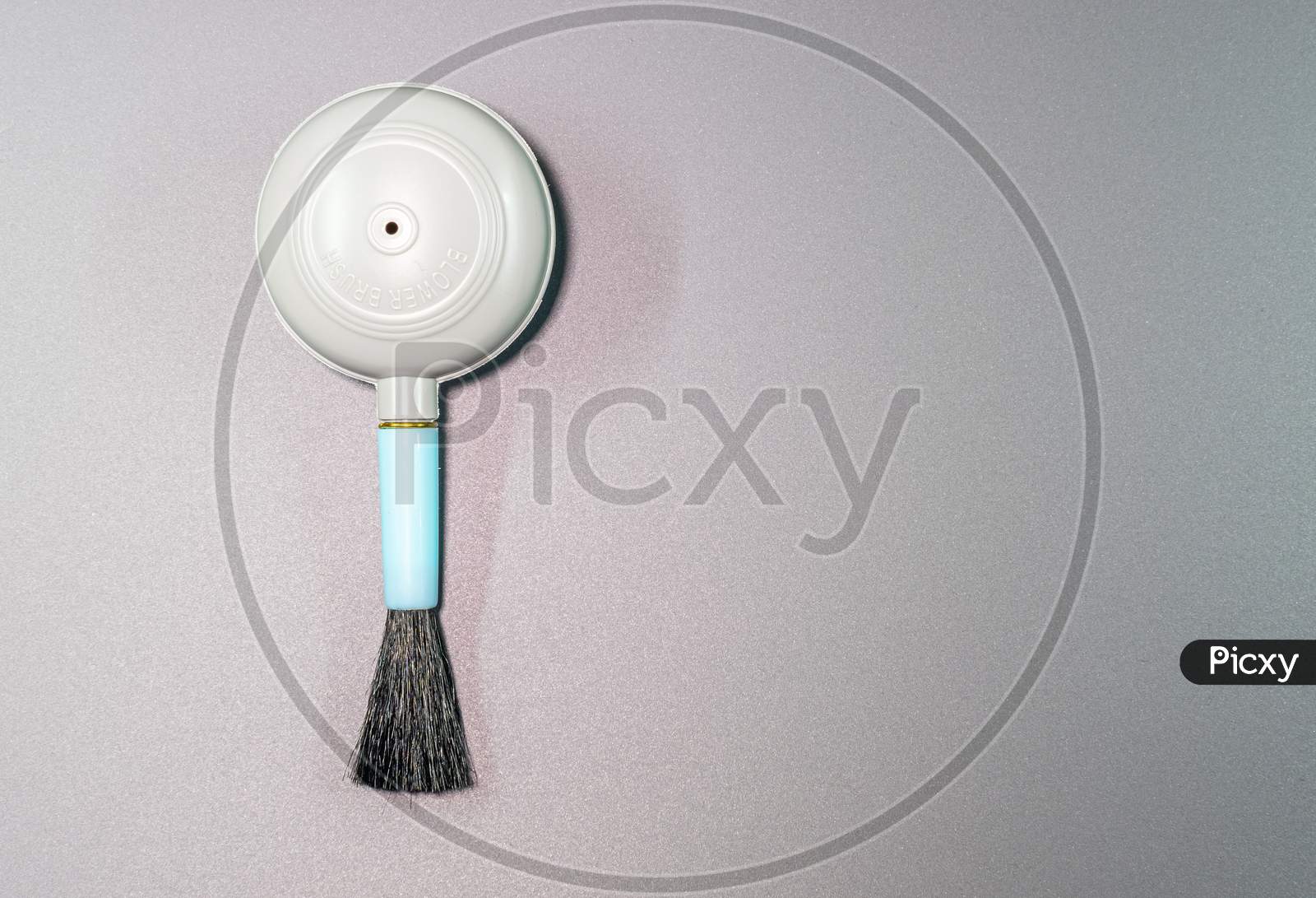 An Isolated View Of Hand Blower Brush In A Gray Background