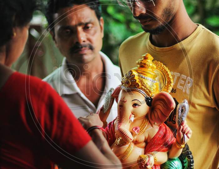 Indian Family Bringing Idol Of Lord Ganesha To Home