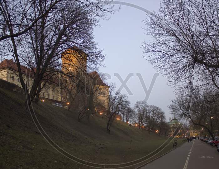 Krakow, Poland - February 21, 2015: Wawel Castle From Below During Night Adjacent To Street At The End Of Winter Season