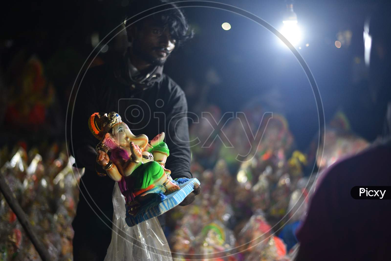 A vendor shows idols of hindu deity, Lord Ganesh ahead of Ganesh Chaturthi/ Vinayaka Chavithi festival in Hyderabad on August 21, 2020.