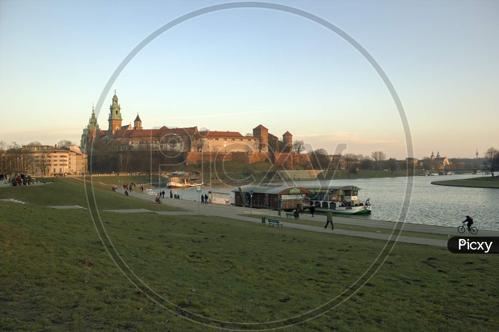 Krakow, Poland - February 21, 2015: Wide Angle View Of Wawel Castle By Vistula River And Restaurant Within Docked Ship