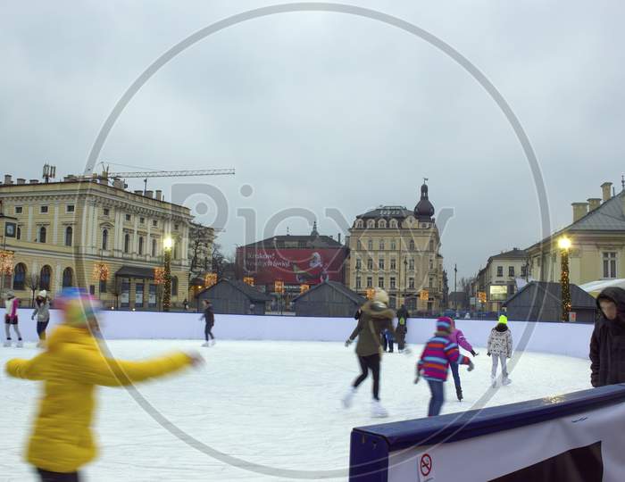 Krakow, Poland - November 30, 2014: Kids Enjoying Ice Skate During Christmas Even Holidays In Winter At City Center Mains Square Before Galeria Krakowska Shoppping Mall
