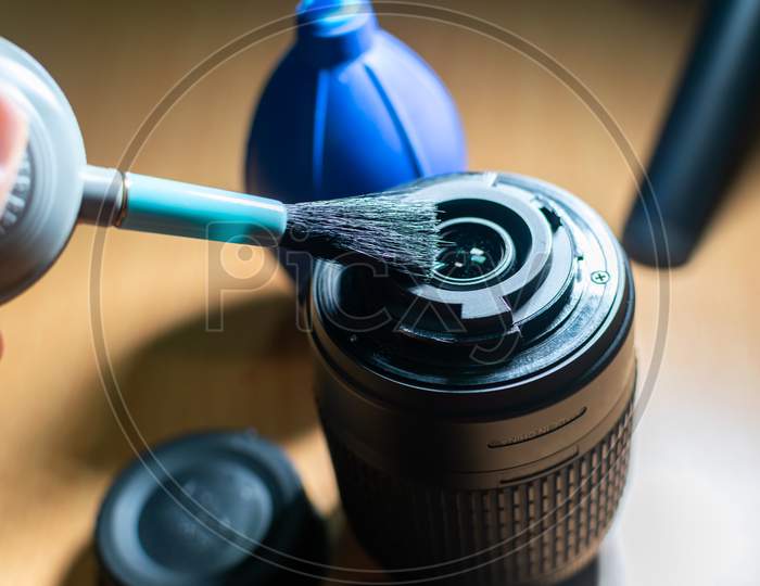 Cleaning Camera Lens With Hand Blower And Brush