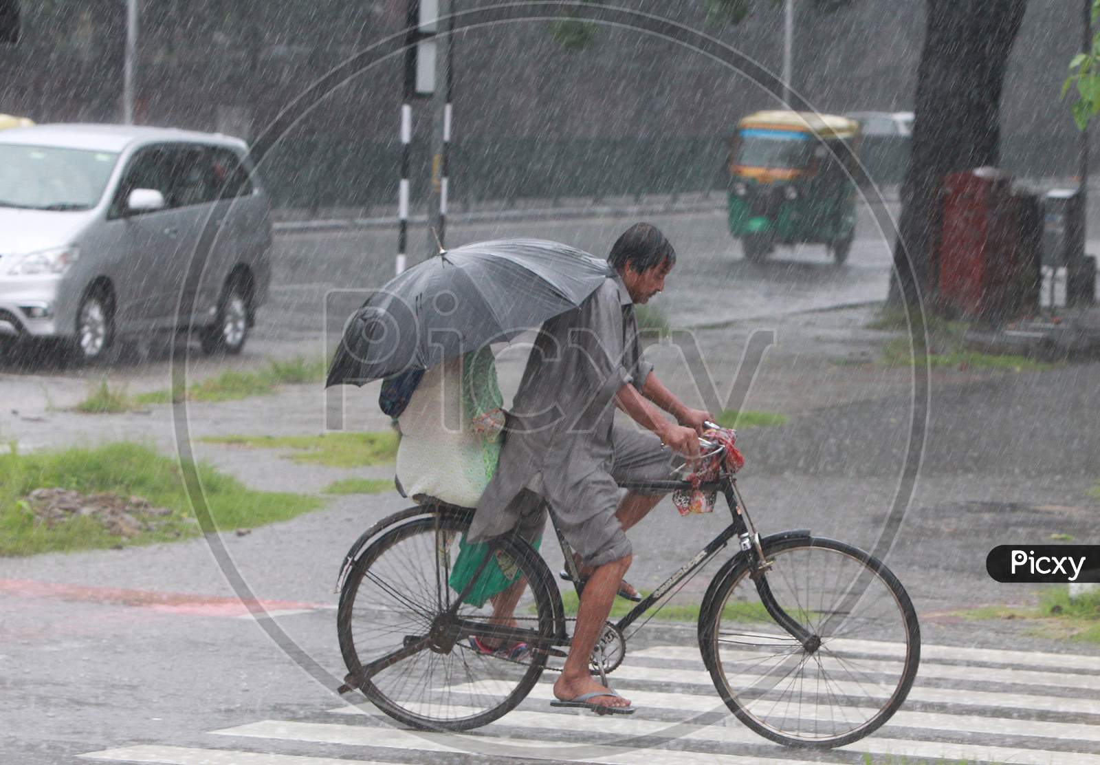 Commuters move during heavy rain in Chandigarh August 21, 2020