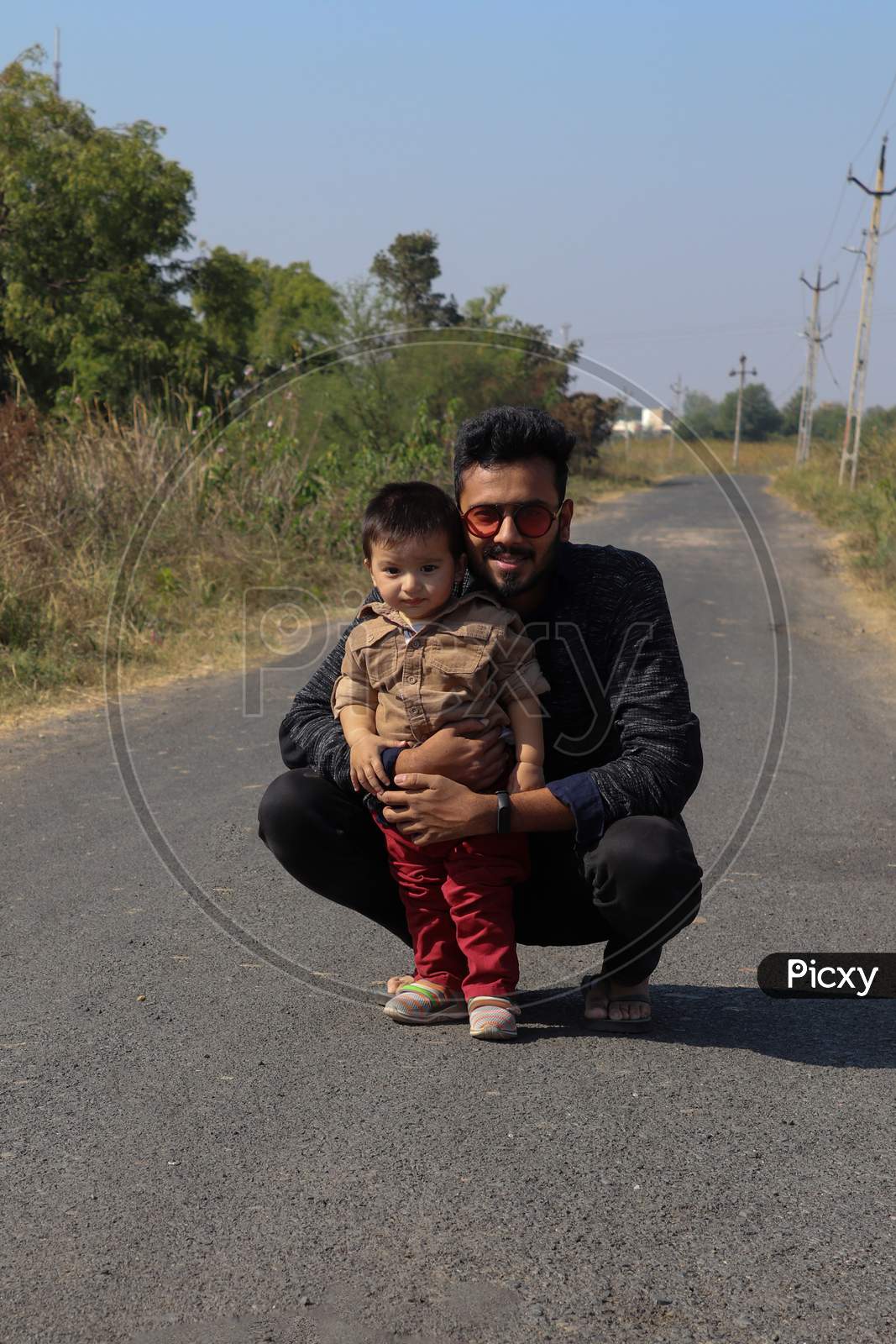 Father And Son On Road On Forest Road Spending Happy Time Together On Nature Background.