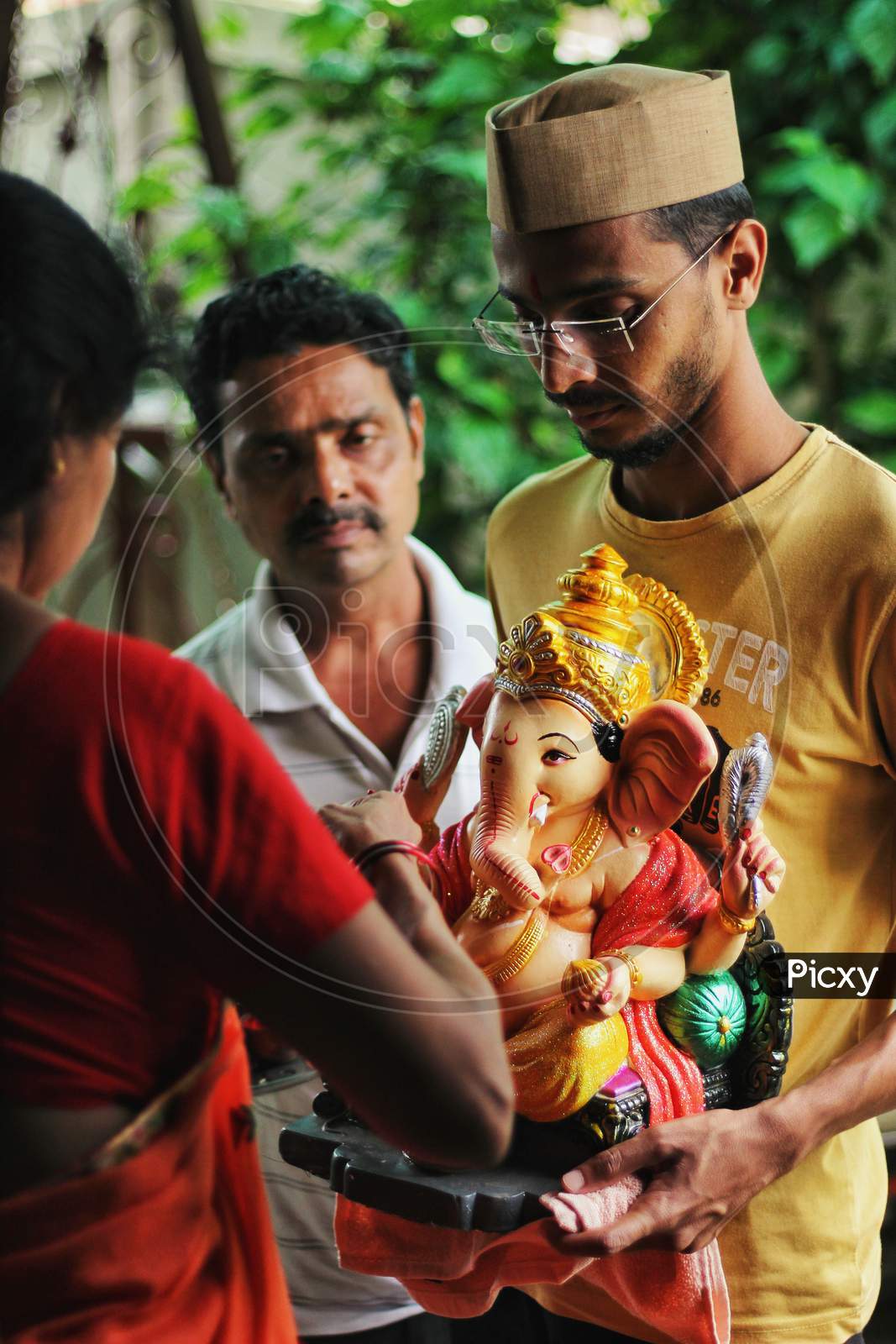 Indian Family Bringing Idol Of Lord Ganesha To Home