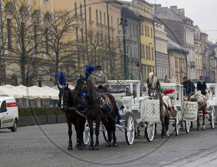 Krakow, Poland - December 16, 2014: Queue Of Horse Ride Carriage For Tourists During Christmas Eve In Winter