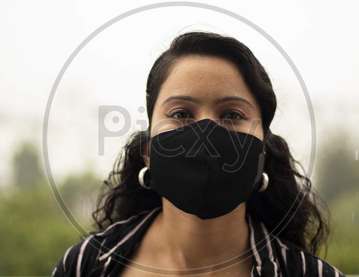 Covid-19 Pandemic Coronavirus A Young Indian Woman In A Protective Black Mask For The Spread Of The Sars-Cov-2 Disease Virus.