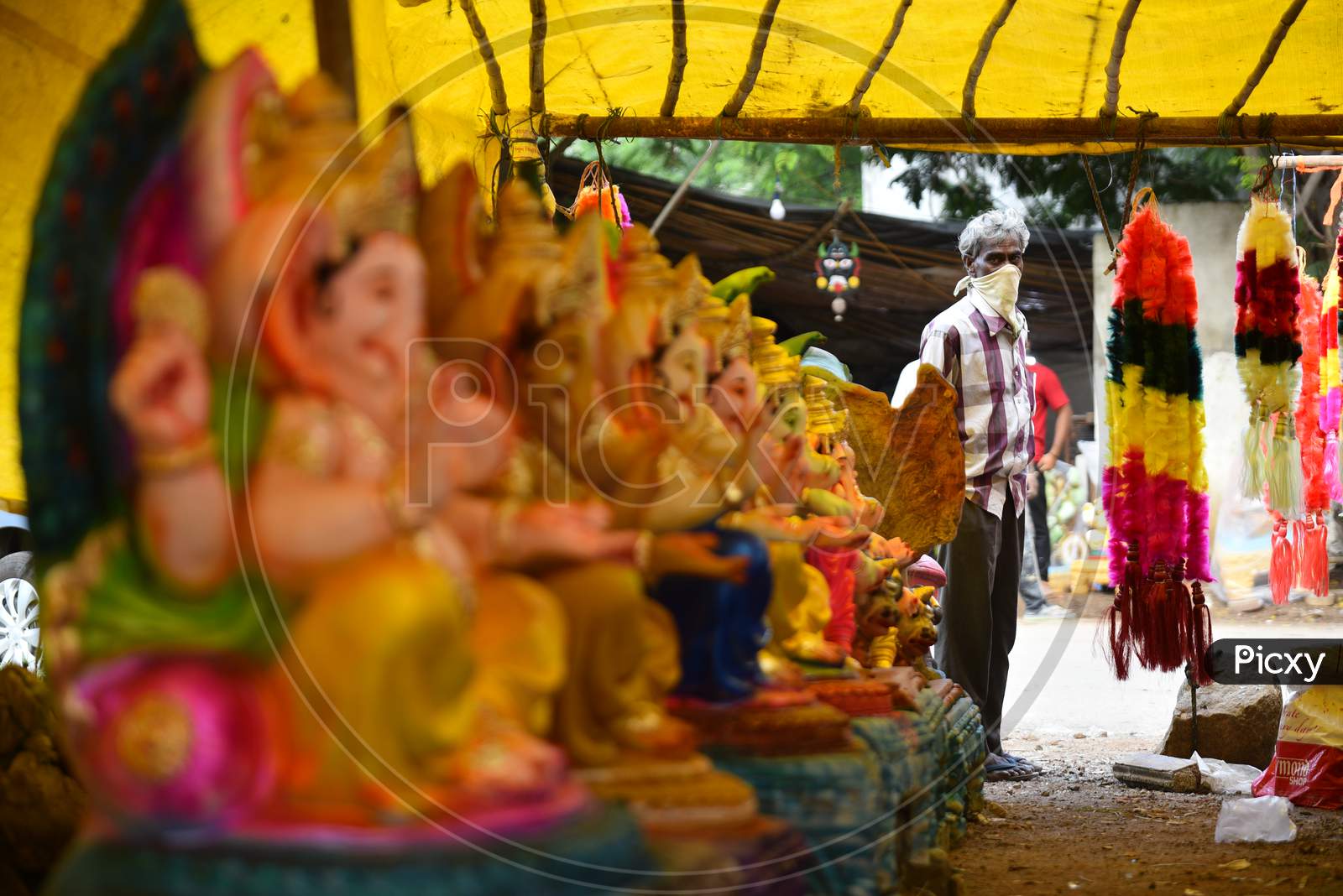 A seller waits for customers of Idols ahead of Ganesh chaturthi in hyderabad, august 21, 2020.