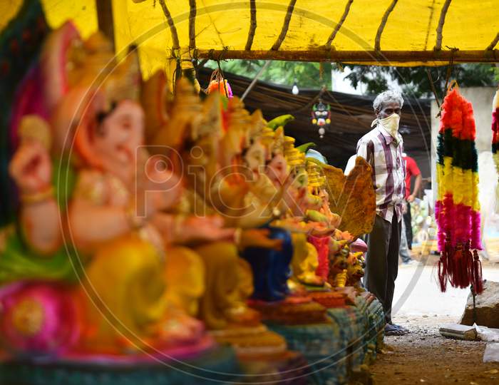 A seller waits for customers of Idols ahead of Ganesh chaturthi in hyderabad, august 21, 2020.