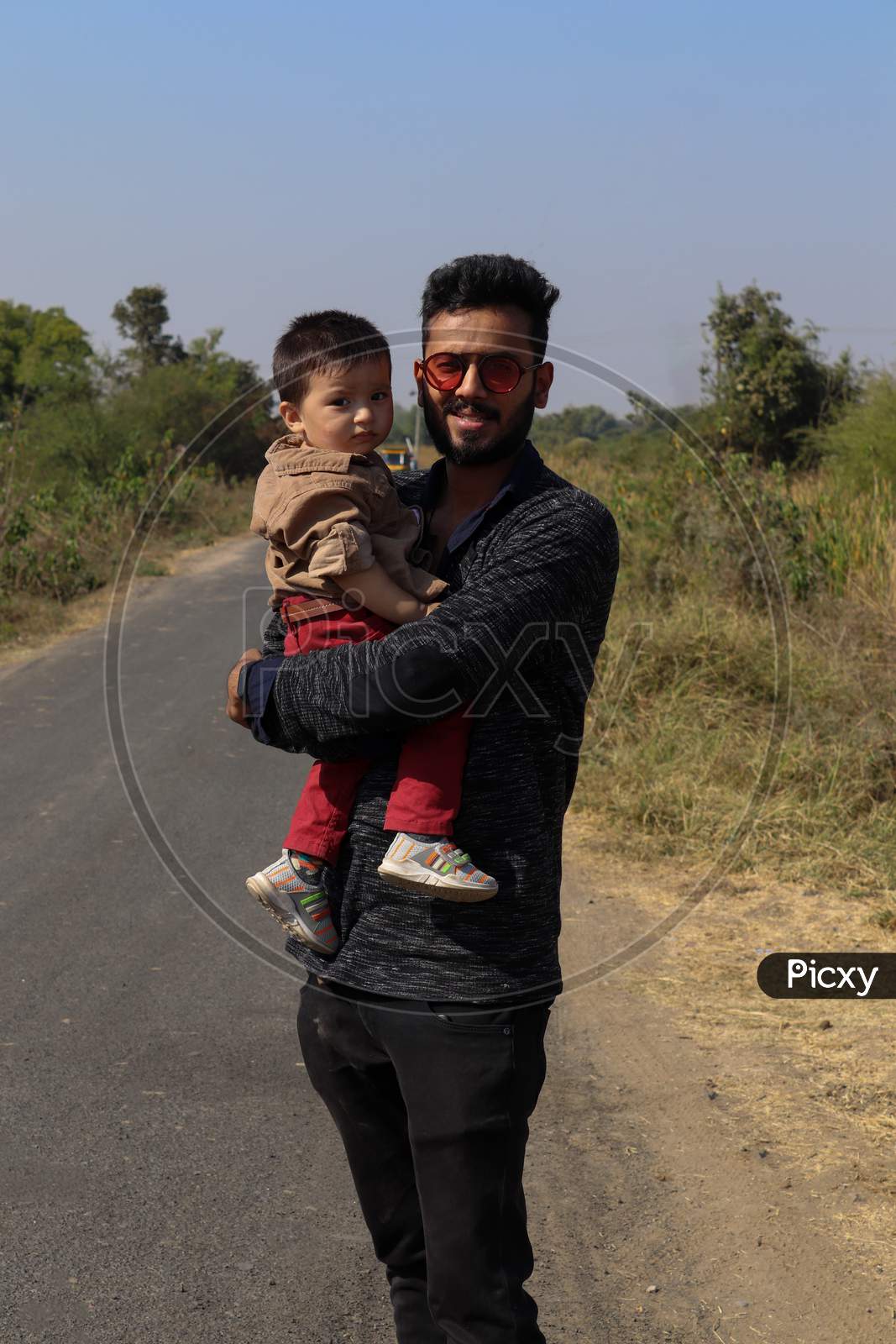 Father And Son On Road On Forest Road Spending Happy Time Together On Nature Background.