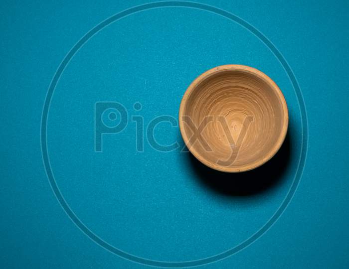 A Close Up View Of Clay Pot In A Blue Background