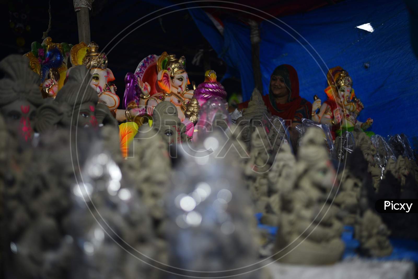 A vendor waits for customers to sell the Idols of hindu deity, Lord Ganesh ahead of Ganesh Chaturthi festival in Hyderabad, August 21, 2020.