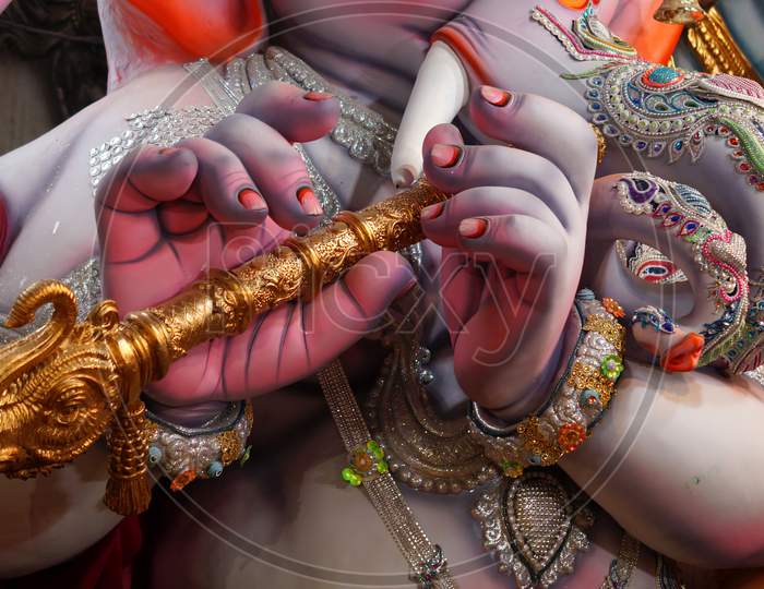 Close-up view  Indian Hindu God Ganesha playing musical instrument flute