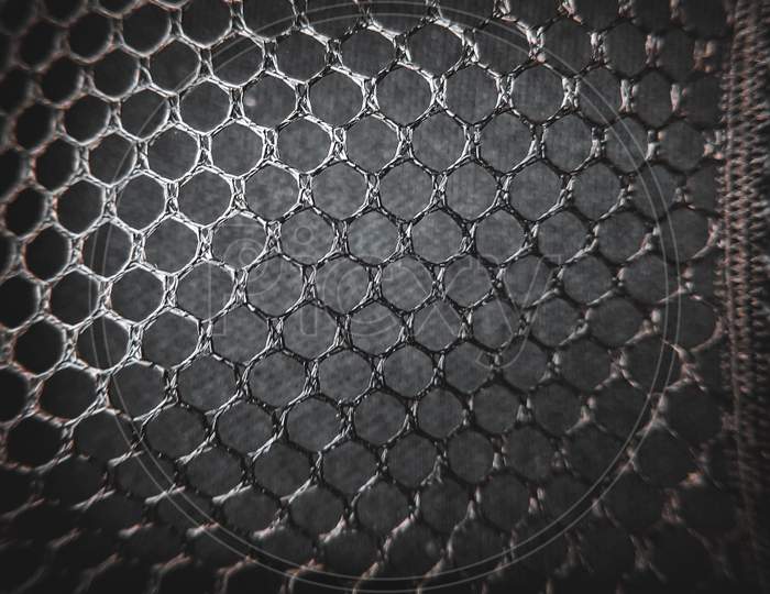 A photo of hexagonal shape net giving texture and surface to the image for creating a wallpaper.