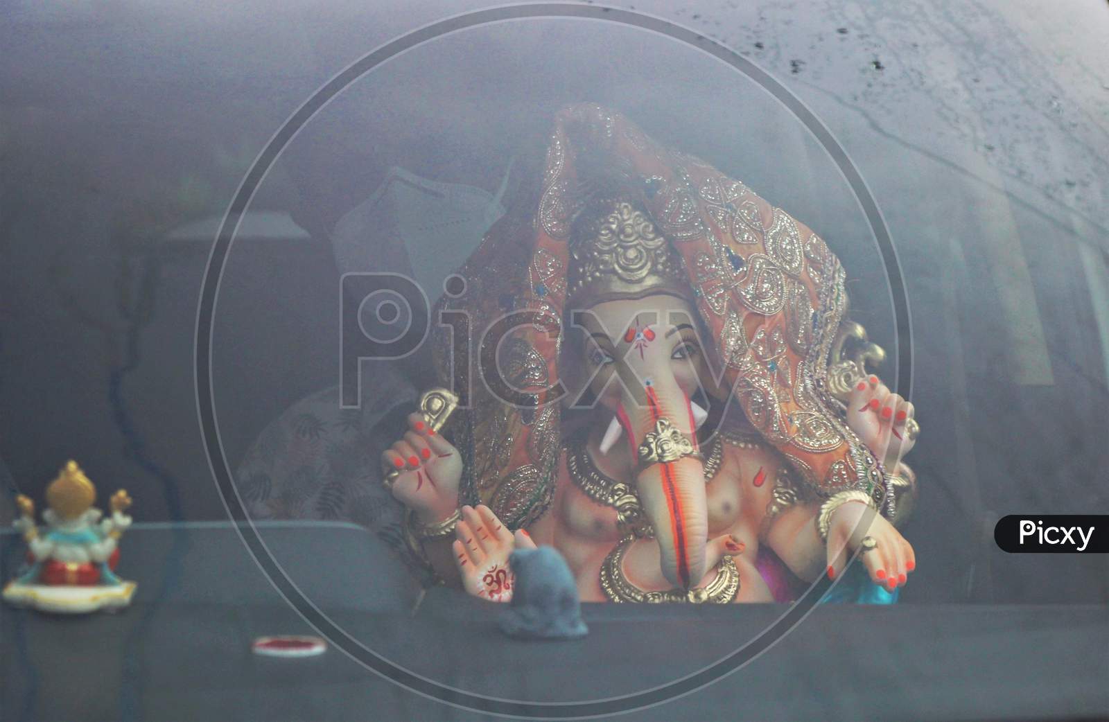 A devotee carries home an idol of elephant-headed Hindu god Ganesha for worship during Ganesh Chaturthi festival celebrations in Mumbai, India, on August 22, 2020.