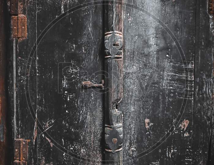 Image of a door made of wood in the old times.
