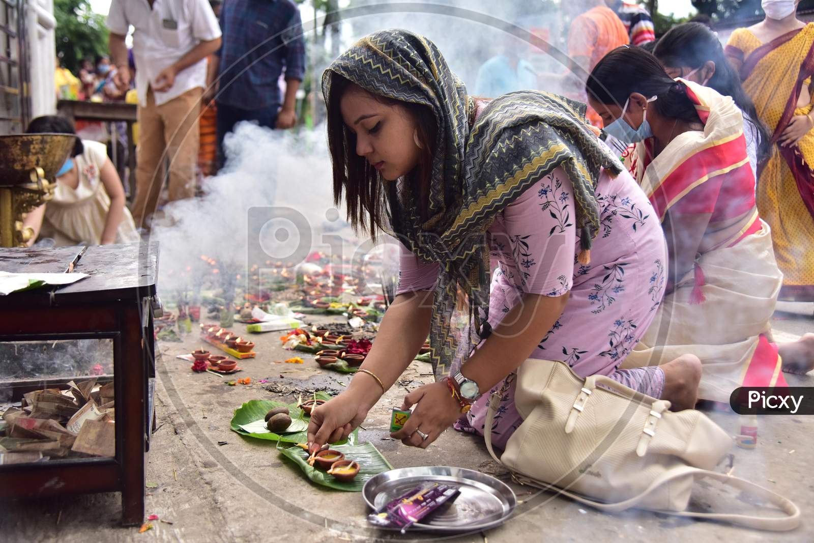 Devotees Lighting The Earthen Lamp To Offer Prayers To Lord Ganesha On The Occasion Of  Ganesh Chaturthi Festival In Nagaon District Of Assam On August 22,2020.
