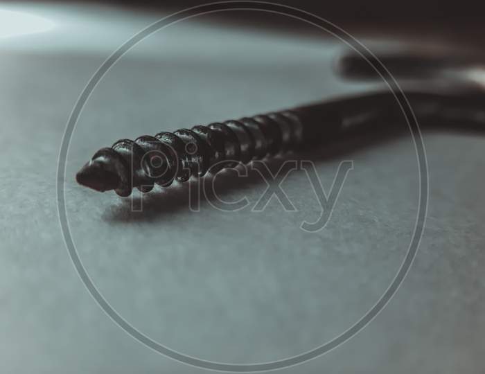 A sharp pointed screw photo with urban theme. macro photography with mobile phone.