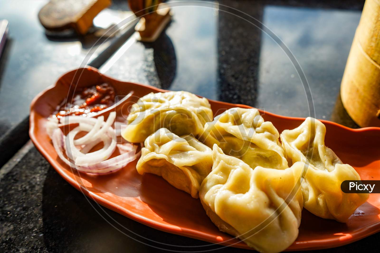 Traditional Dumpling Momos Food From Nepal Served With Tomato Chutney Over Moody Background. Selective Focus