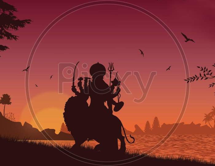 Durga devi silhouette in sunset