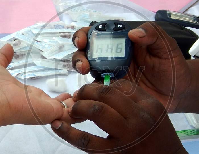 Close-up view of Indian Doctor checking Blood sugar level of a patient