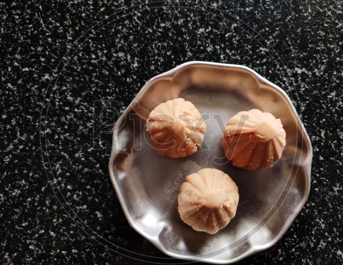 Ukadiche Modak on plate on table, black background, India's famous sweet