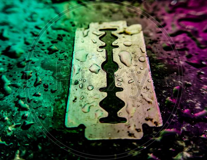 Waterdroplets on Razor ( Blade) with colurful light, creative photography