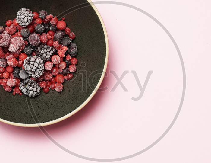 Red Berries And Black Berries On A Black Plate And Slate Background. Flat Lay. Gastronomic Food