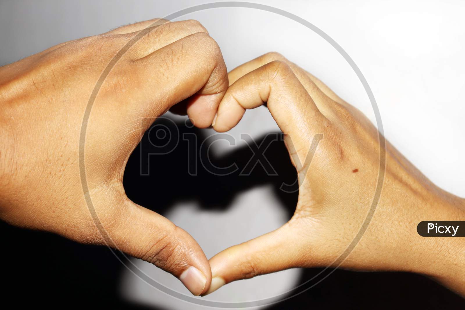 A Boy And Girl Making Heart Shape With Both Hand