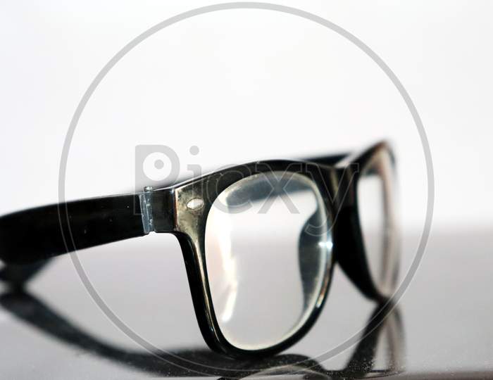 Isolated Eye Glass Put On Working Desk With White Background
