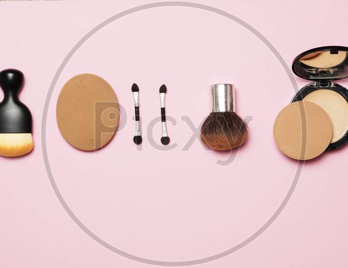 Makeup Utensils On A Pink Background. Flat Lay.