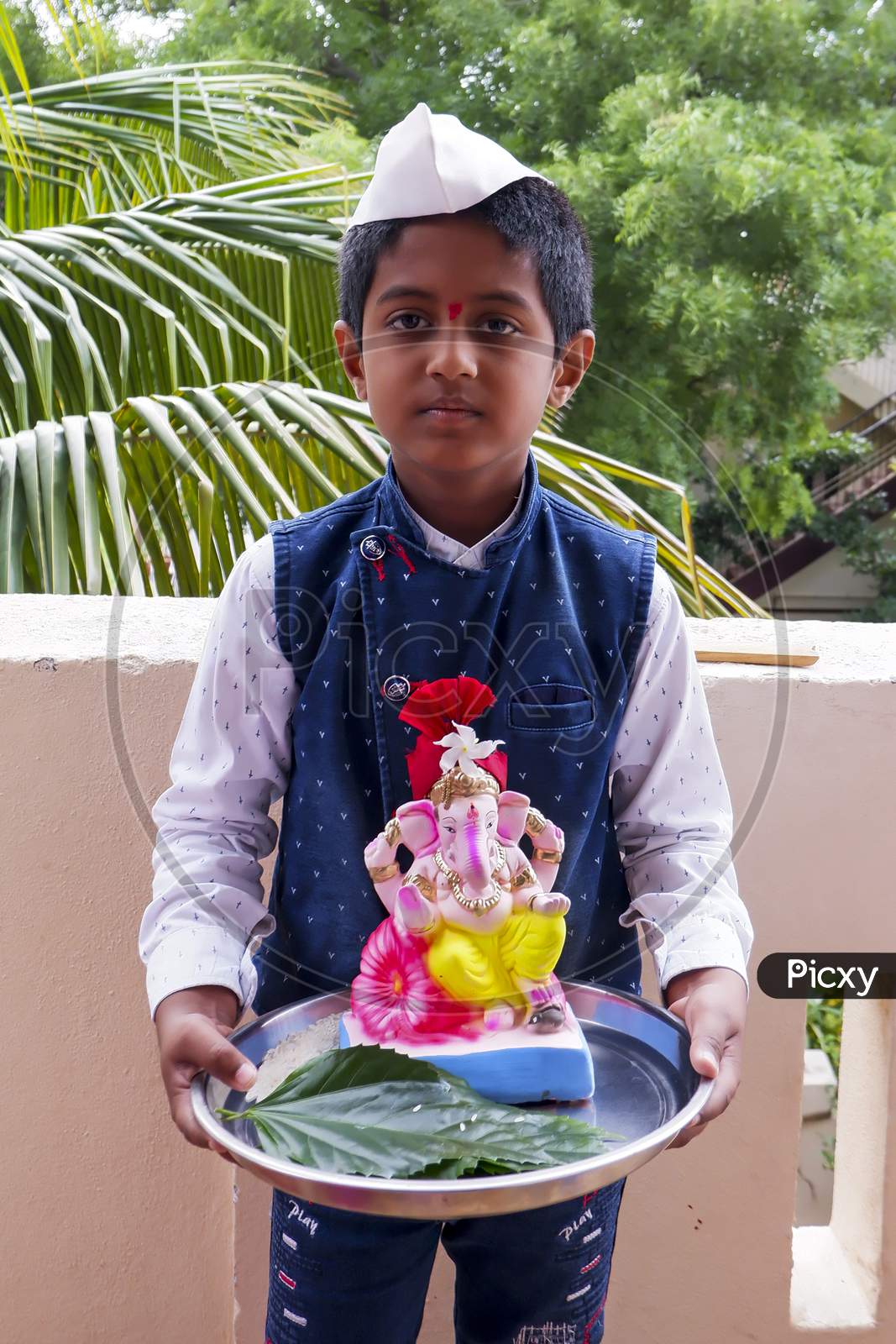 Boy Bringing Colorful Idol Ganesha To Home For Ganesha Chaturthi