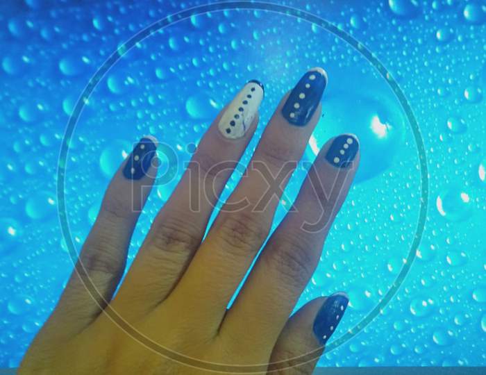 woman hands with manicure and attractive nail art of heart shape, stripes and dotted style.