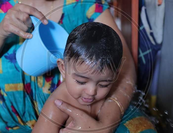 An Infant Toddler Baby Boy Wet With Foam Enjoying Shower Bathing In His Pool