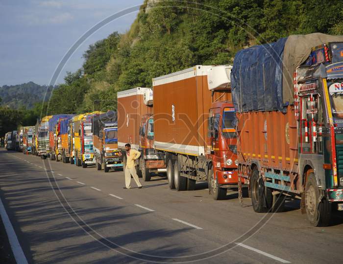 Stranded Trucks wait for the opening of the Jammu-Srinagar national highway, that was closed due to a landslide in Ramban area on the outskirts of Jammu on August 23,2020.