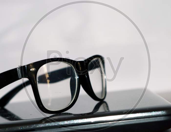 Isolated Eye Glass Put On Working Desk With White Background