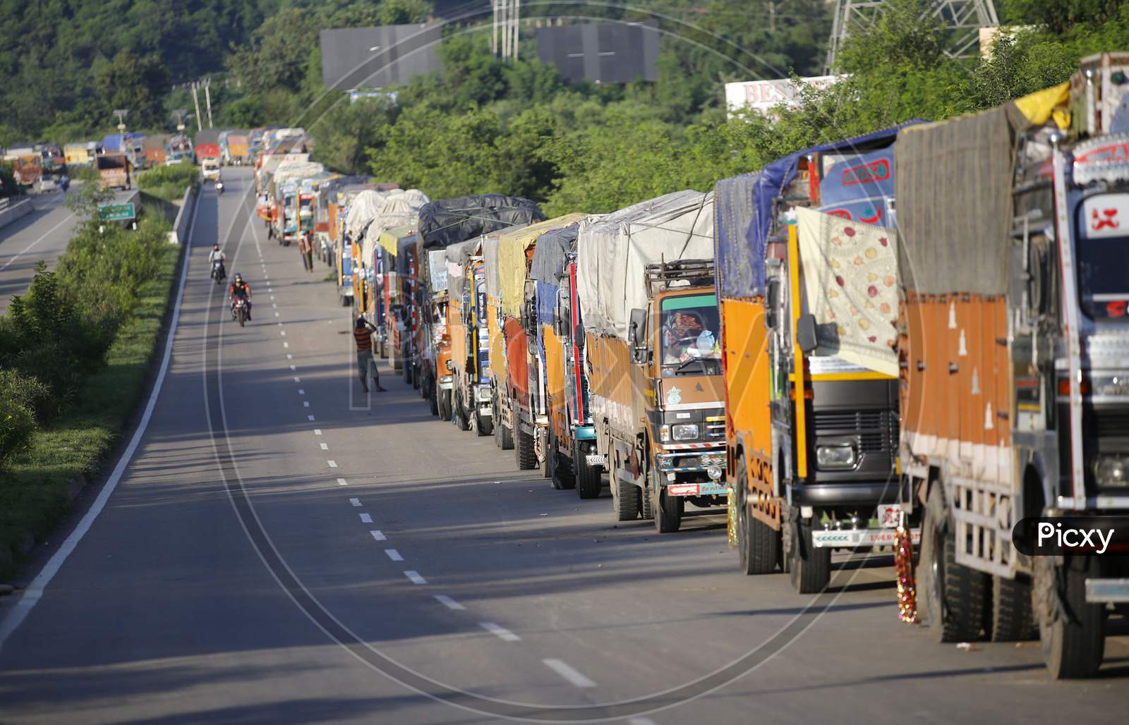 Stranded Trucks wait for the opening of the Jammu-Srinagar national highway, that was close due to landslide in Ramban area on the outskirts of Jammu on August 23,2020.