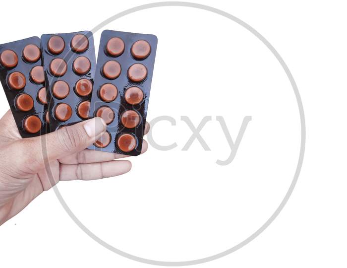 Man Holding Medical Tablets In Hand Isolated