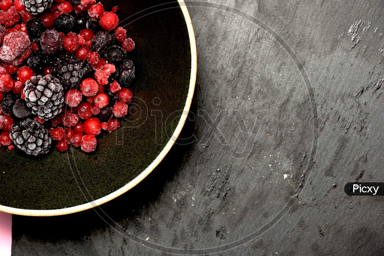 Red Berries And Black Berries On A Black Plate And Slate Background. Flat Lay. Organic Gastronomic Food