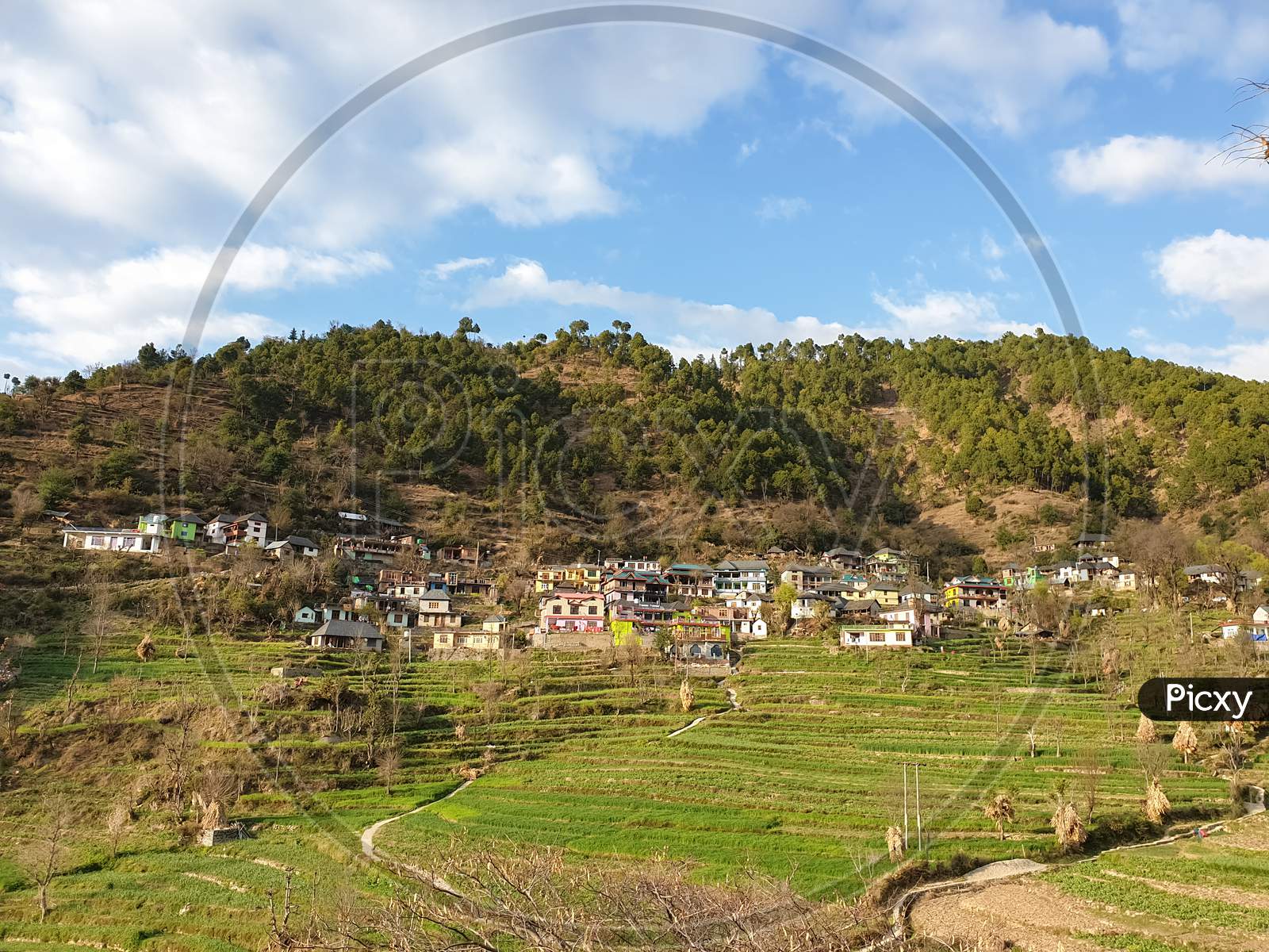 Wide angle view of a beautiful village in amazing mountains with terraced farm in hilly area of Himachal Pradesh, India