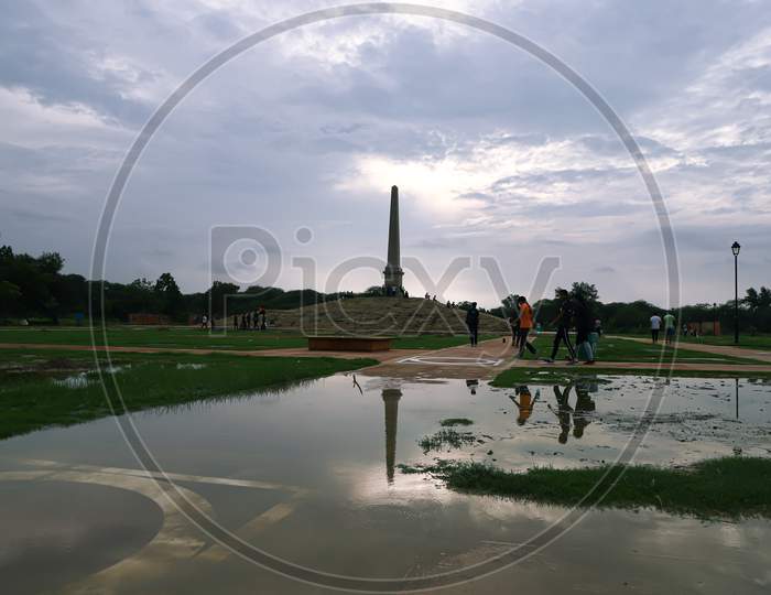 A beautiful scenery of the greenery and reflection in coronation park  delhi