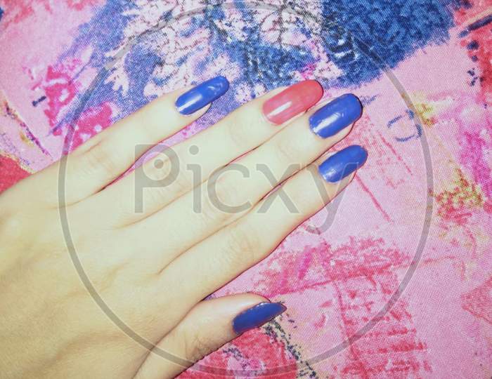 woman hands with manicure and attractive nail art of heart shape, stripes and dotted style.