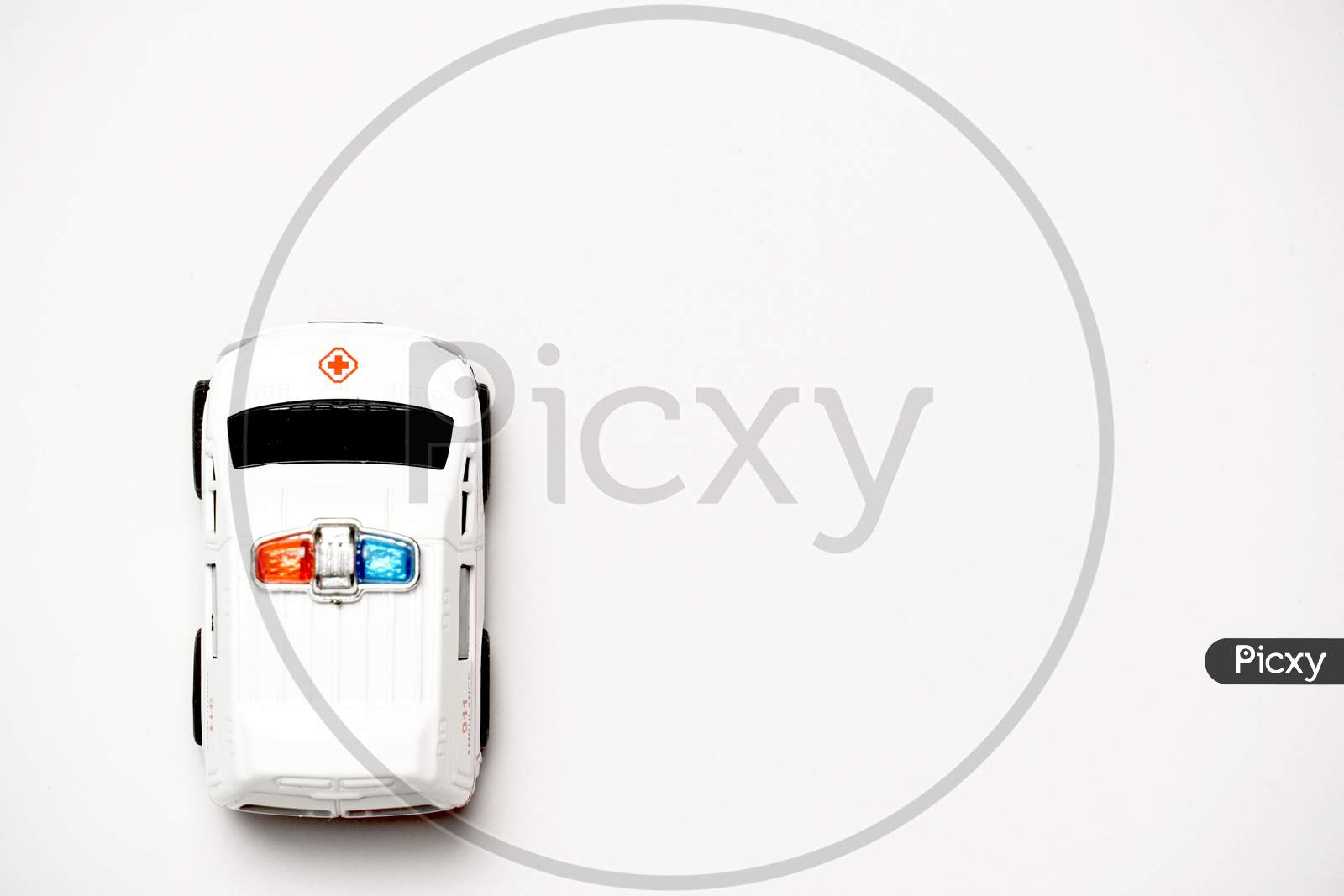 Toy Ambulance On White Background With Copy Space. Flat Lay .Flat Design. Concept Of Traveling By Car