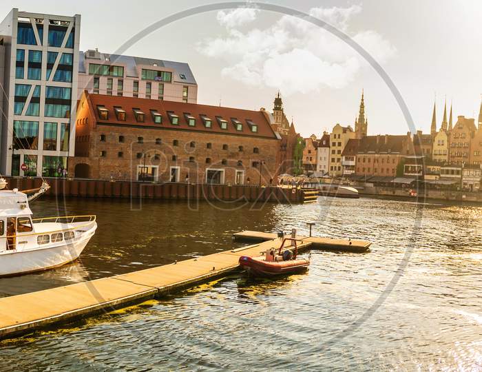 Gdansk, North Poland - August 13, 2020: Sunset Panoramic View Of Summer Around Motlawa River Adjacent To Beautiful Polish Architecture Near Baltic Sea And Boats Docked
