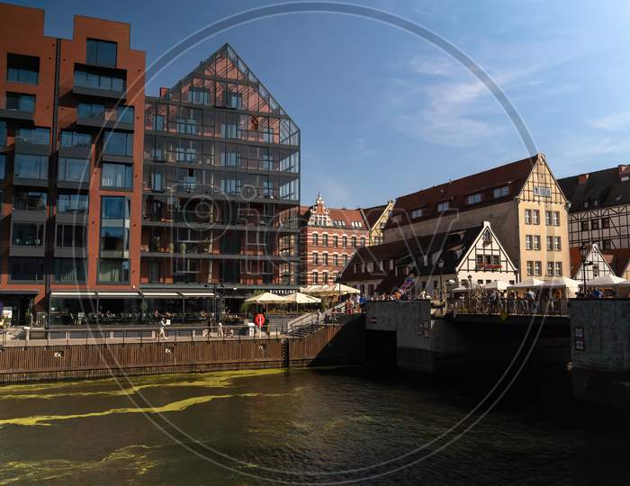 Gdansk, North Poland - August 13, 2020: People Walking Dining And Riding Motor Boat In Summer In Motlawa River Adjacent To Beautiful European Architecture Near Baltic Sea During Covid 19 Pandemic