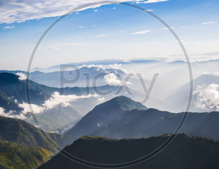 The vertical landscape of the Himalayan mountain ranges, fog and clouds are spreading this beauty even more dramatically